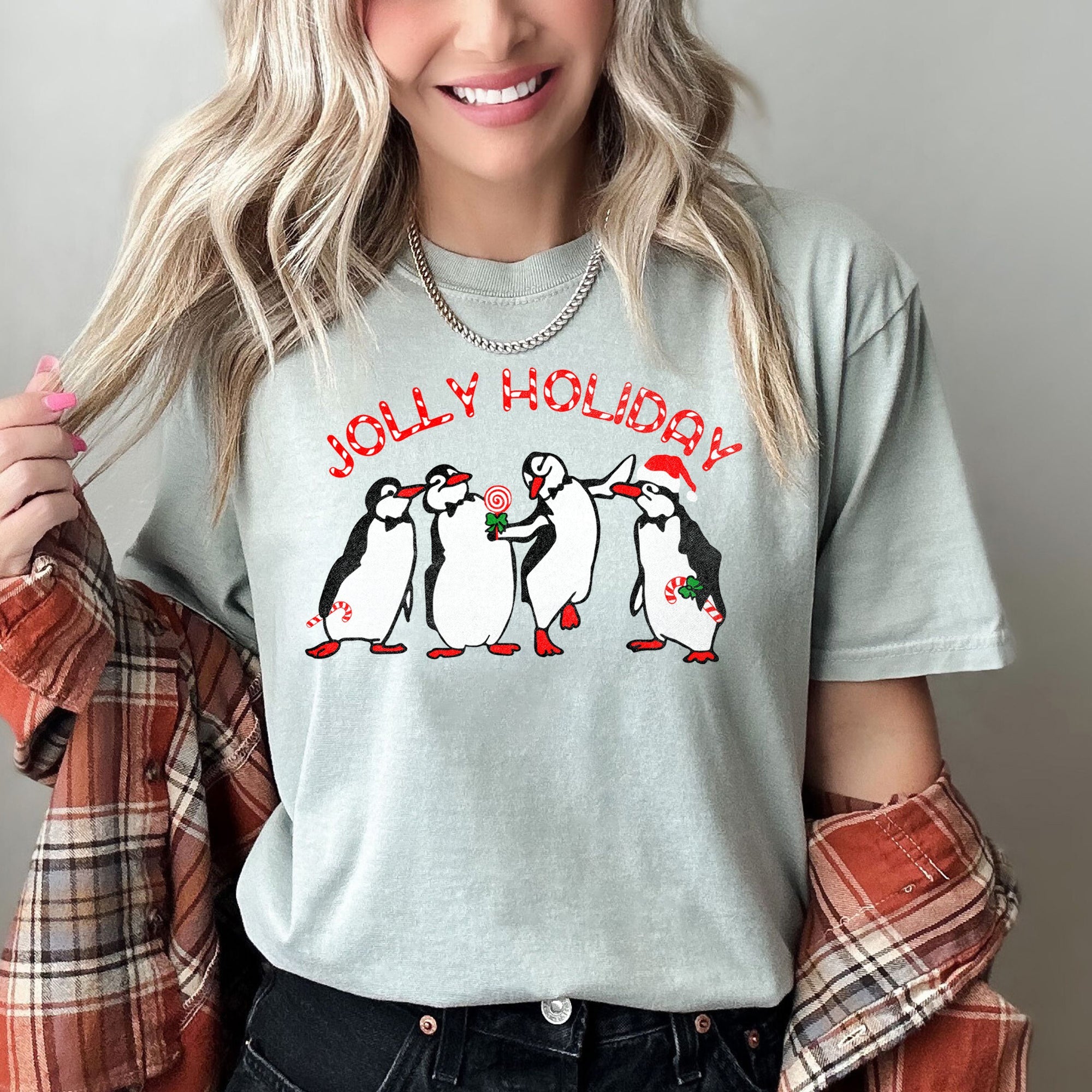 Jolly Holiday Penguins Christmas Parade In Cozy Winter Village Scene With Snowflakes And Cheer Comfort Colors Tee