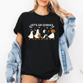 Let's Go Ghouls Geese With Witch Hats For Halloween Night Grinning Goose Parade Graphic Tee