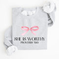 She Is Worthy Bible Verse Christmas Bow Pink Proverbs Soft Girl Era Inspirational Sweatshirt