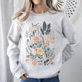 Whimsical Garden Floral Design With Delicate Petals And Lush Leaves And Blooms Sweatshirt